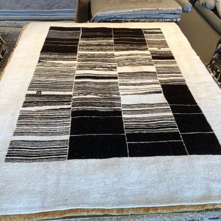 Eco-friendly 9x12 handmade hemp area rug with wide ivory border and irregular black and ivory stripes, sustainable minimalist design for modern interiors.