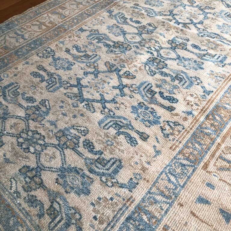 A refined antique Persian rug with an intricate allover design set against a soft sky blue field. Delicate motifs and a beautifully aged patina create a piece that feels both timeless and effortlessly livable, 4x6