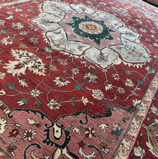 A modern Serapi rug handmade in Turkey featuring a bold floral medallion and an open, airy composition. A refined balance of tradition and modern elegance.