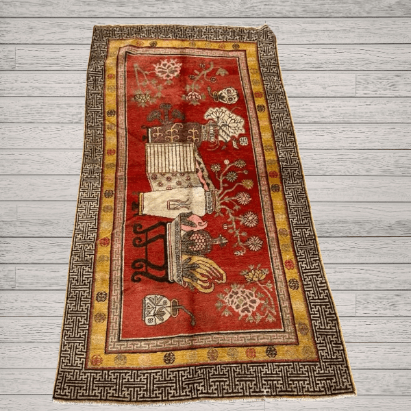 A richly detailed antique Khotan rug Samarkand vase design with a deep red field, intricate vase motifs, and a distinctive Chinese-inspired border. Bold, layered, and highly decorative, 4'0" x 8'6"