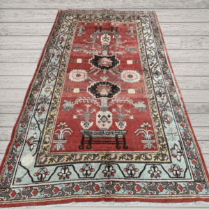 A character-rich antique Khotan rug with a deep red field and rare figurative table motifs. Layered, symbolic, and highly decorative, this piece offers both narrative and refined presence, 4'7" x 6'7"