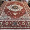 A modern Serapi rug handmade in Turkey featuring a bold floral medallion and an open, airy composition. A refined balance of tradition and modern elegance.