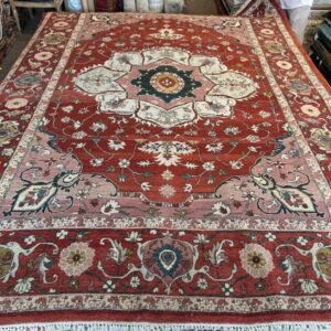 A modern Serapi rug handmade in Turkey featuring a bold floral medallion and an open, airy composition. A refined balance of tradition and modern elegance.