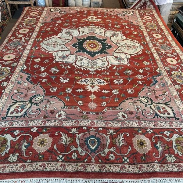 A modern Serapi rug handmade in Turkey featuring a bold floral medallion and an open, airy composition. A refined balance of tradition and modern elegance.