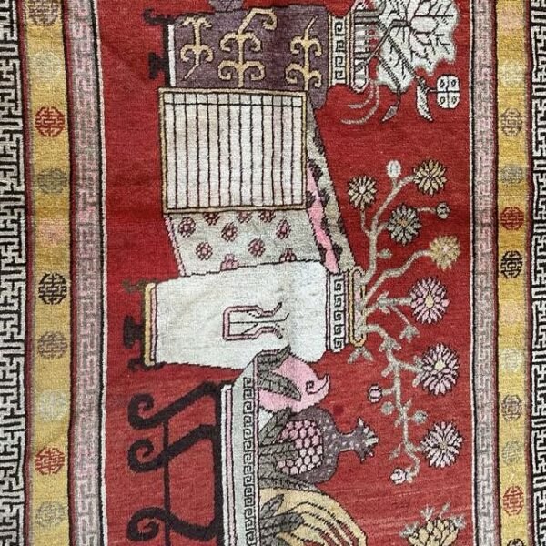 A richly detailed antique Khotan rug Samarkand vase design with a deep red field, intricate vase motifs, and a distinctive Chinese-inspired border. Bold, layered, and highly decorative, 4'0" x 8'6"