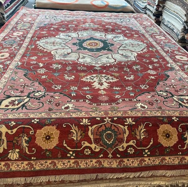 A modern Serapi rug handmade in Turkey featuring a bold floral medallion and an open, airy composition. A refined balance of tradition and modern elegance.