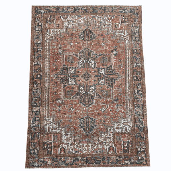 A striking antique Heriz rug featuring a bold geometric medallion and stylized tribal motifs in a beautifully softened, antique-washed palette, 9'2" x 12'5"