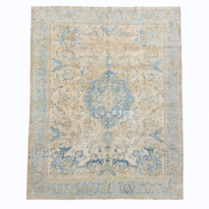 An elegant antique Persian Tabriz rug featuring a traditional central medallion surrounded by delicate floral motifs. Its ivory, beige, and blue palette has been beautifully softened with an antique wash.