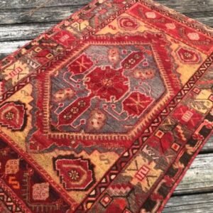 A vintage Turkish rug from the Cappadocia region of central Anatolia ffeaturing a striking medallion design enriched with intricate tribal motifs