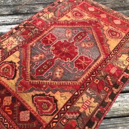 A vintage Turkish rug from the Cappadocia region of central Anatolia ffeaturing a striking medallion design enriched with intricate tribal motifs