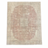 A beautiful large antique Turkish  rug with an elegant muted blush field, delicate beige and ivory floral motifs, and a small central medallion. Its softly muted palette and antique-washed finish give this substantial rug a timeless, sophisticated character, 11' x 13'5"