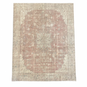 A beautiful large antique Turkish  rug with an elegant muted blush field, delicate beige and ivory floral motifs, and a small central medallion. Its softly muted palette and antique-washed finish give this substantial rug a timeless, sophisticated character, 11' x 13'5"
