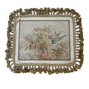 Elegant silk tapestry cushion cover featuring delicate flowers and a bird in flight in soft ivory, blush, sage, olive, and dusty blue. Finished with intricate trim and elaborate decorative fringe.