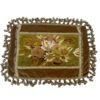 Savonnaire floral cushion cover A distinctive vintage French cushion cover featuring a decorative Savonnerie-style floral panel, framed by layered trims and finished with a full tassel fringe on all four sides.