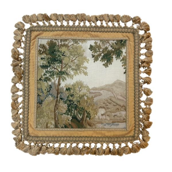 A gorgeous vintage French cushion cover featuring an exquisite Aubusson-style landscape panel in silk. The traditional pastoral scene is framed by a decorative border and finished with tassel fringe all around.